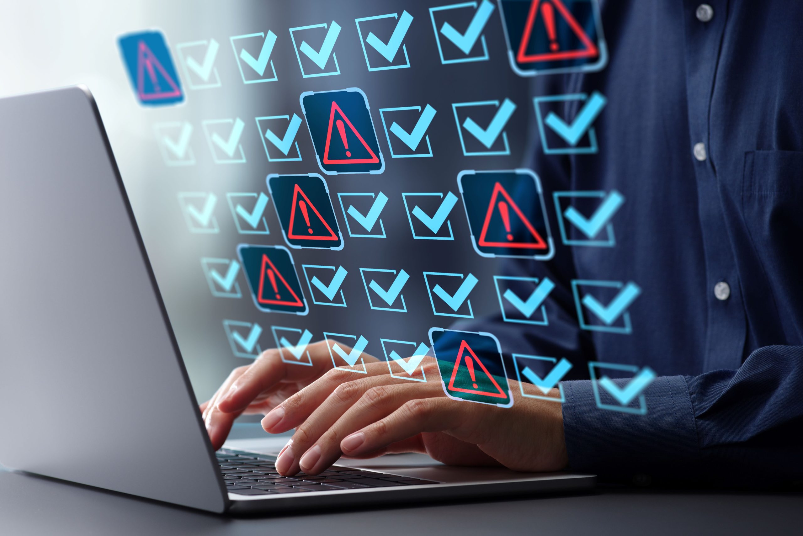 Image of a person at a laptop with a series of Blue checks and red warning triangles in a grid